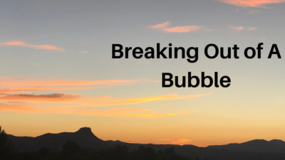 Arizona sunset with pink clouds with the words Breaking Out of A Bubble