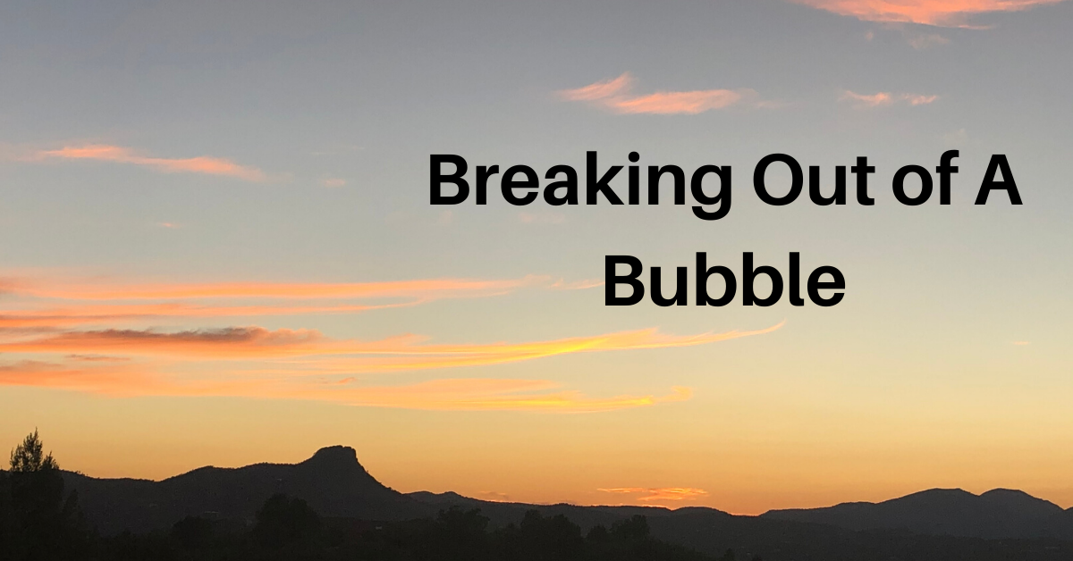 Arizona sunset with pink clouds with the words Breaking Out of A Bubble